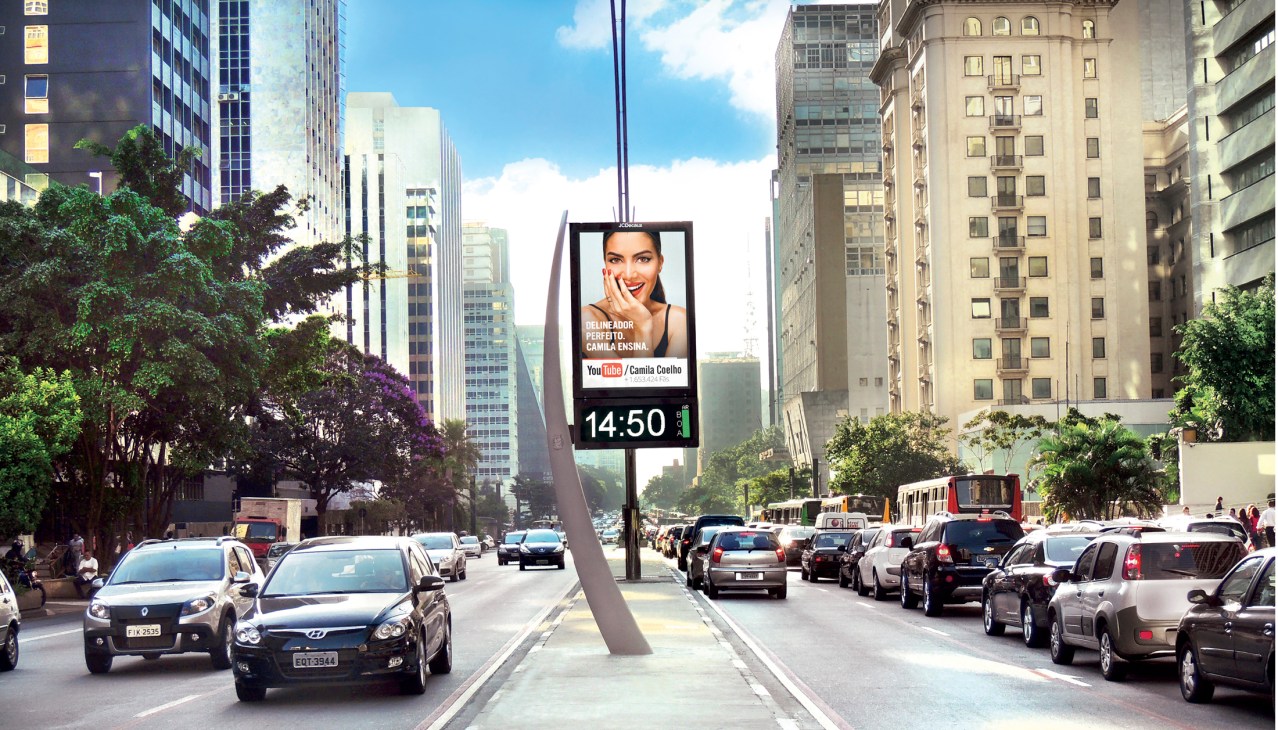 Digital billboard displaying an advertisement on a busy street in São Paulo with traffic and urban buildings