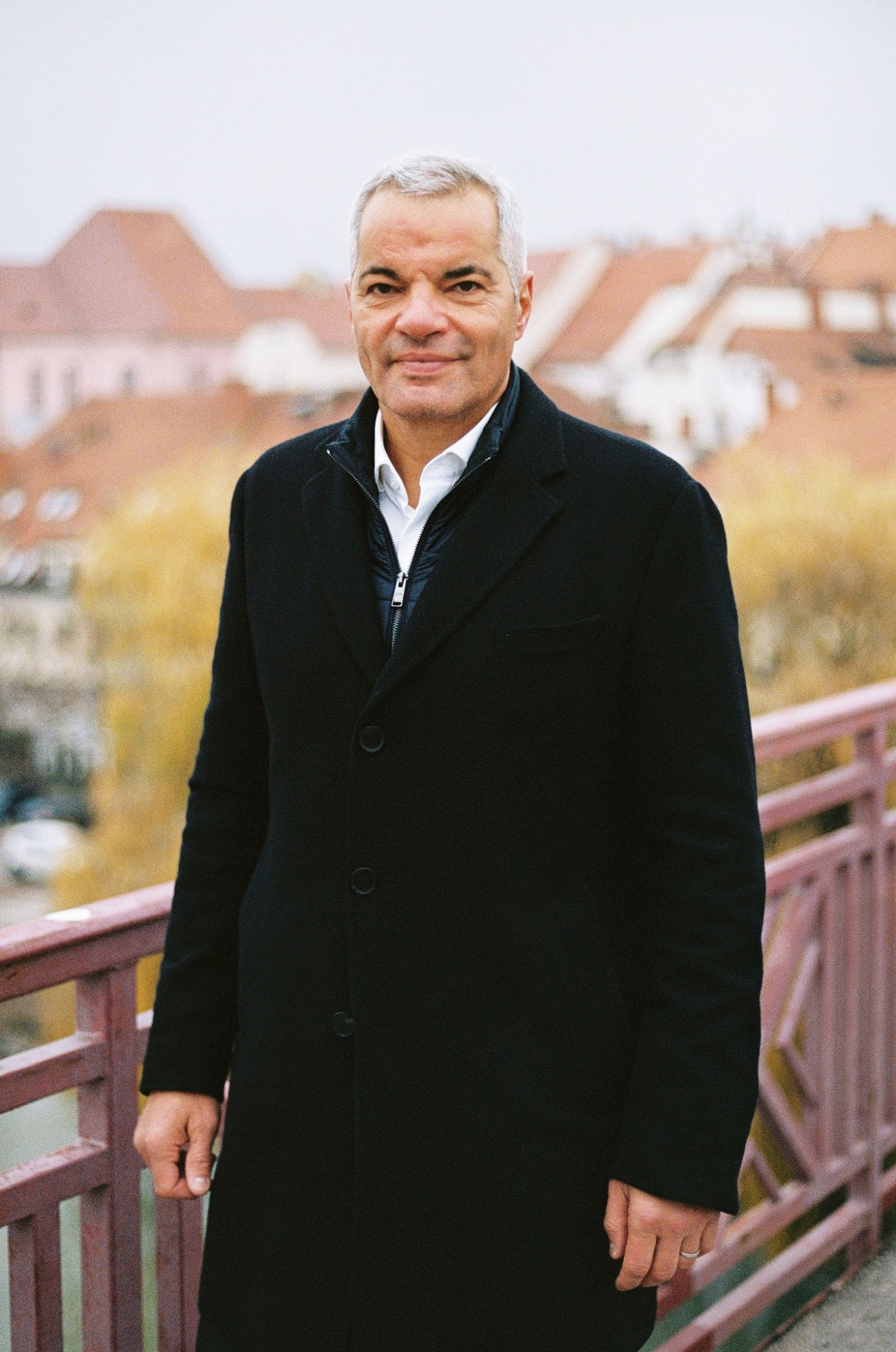 Sasa Arsenovic, Mayor of Maribor, standing on a bridge wearing a dark coat