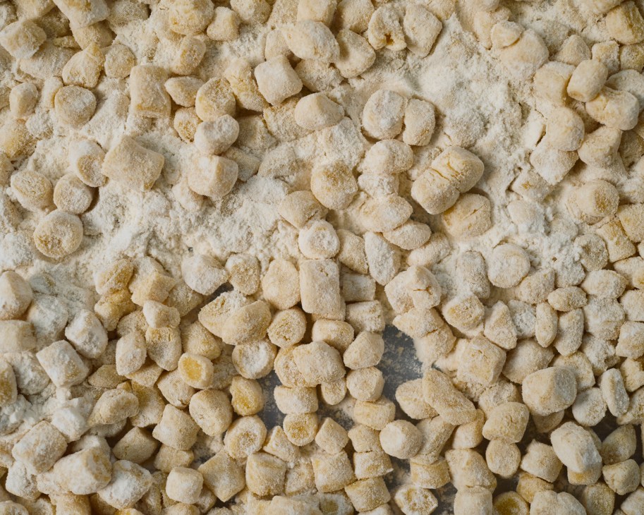 Close-up of golden struffoli, honey-coated fried dough balls from Scaturchio bakery in Naples.