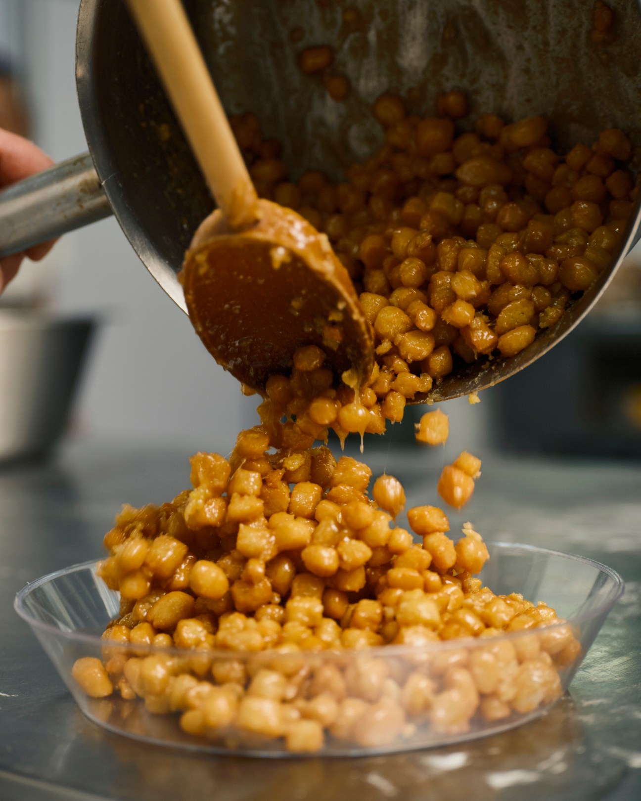 A ladle pours honey-coated struffoli into a bowl at Scaturchio pastry shop in Naples.