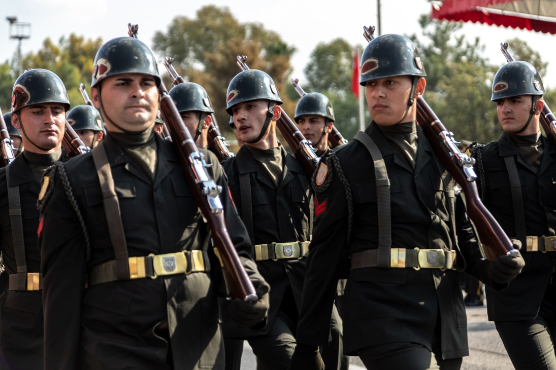 Turkish soldiers in military uniforms and helmets holding rifles during independence day parade in Lefkosa