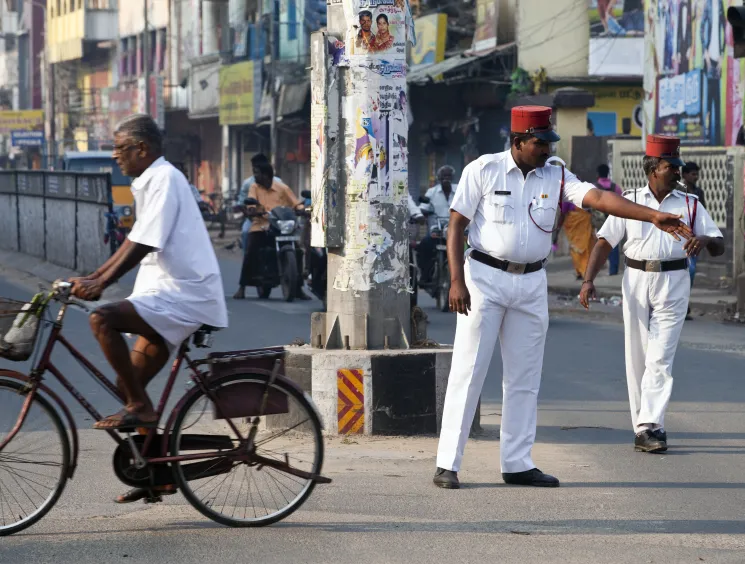 policeman directs traffic wearing a French-style uniform