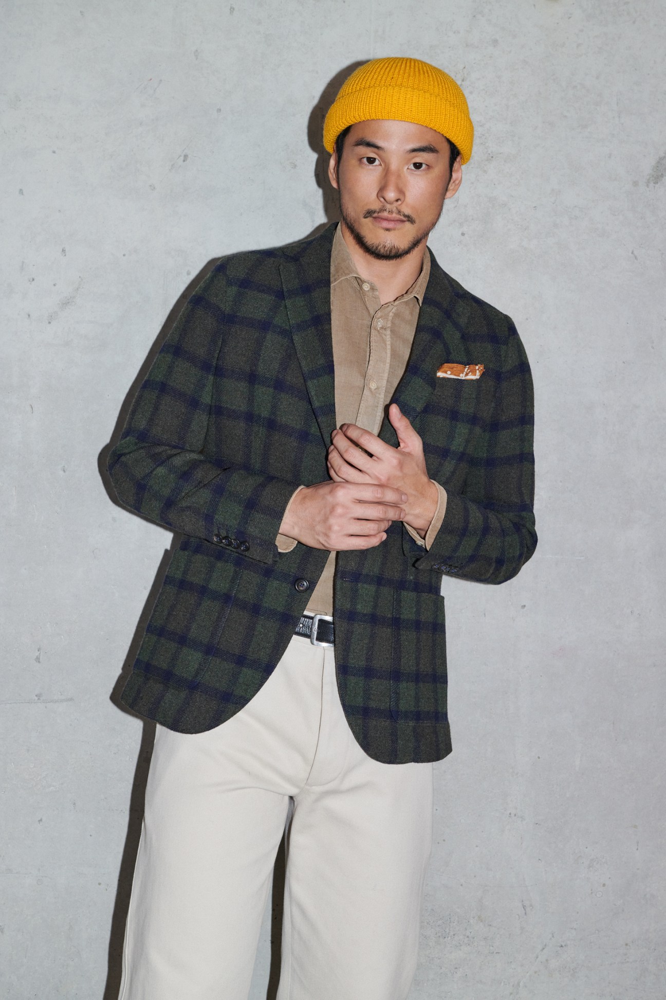 Man in casual jacket and trousers with beanie and pocket square details