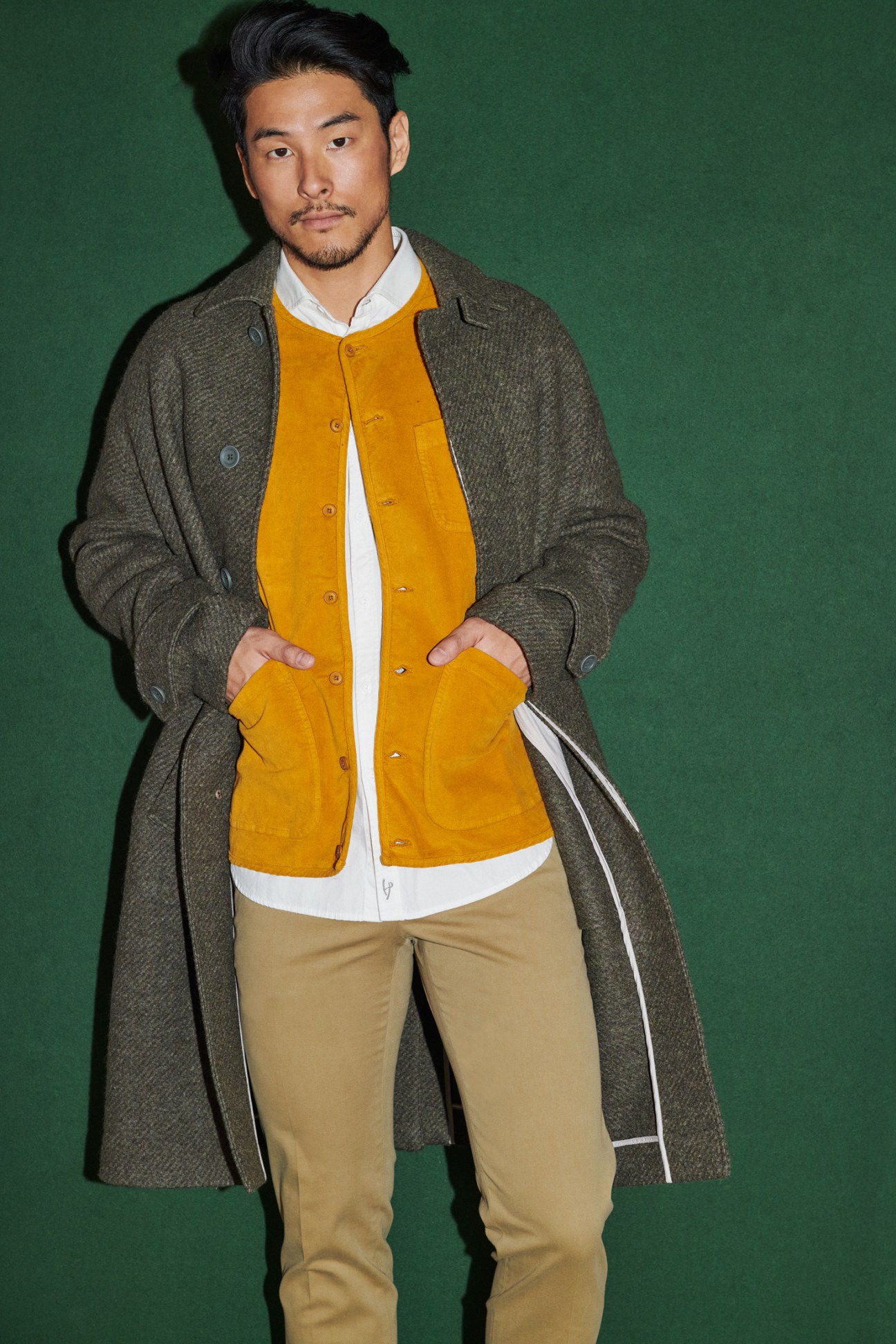 Man in layered outerwear with coat over jacket in sophisticated styling