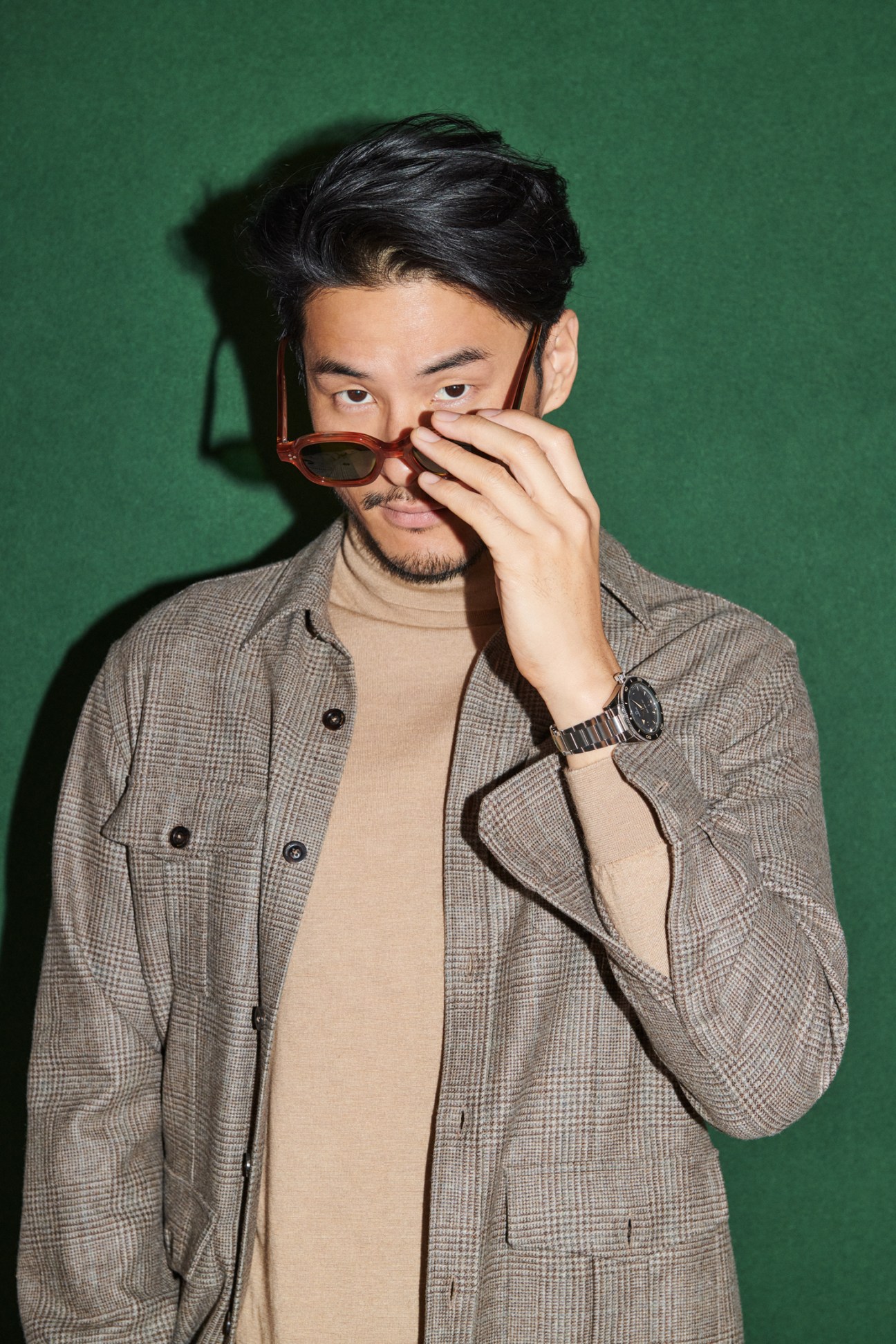 Man in jacket and rollneck with sunglasses and luxury watch