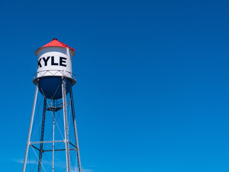 Kyle water tower with red roof against clear blue sky