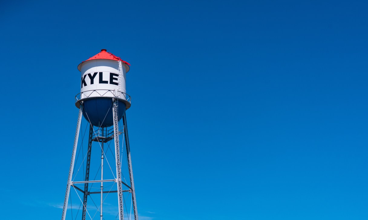 Kyle water tower with red roof against clear blue sky