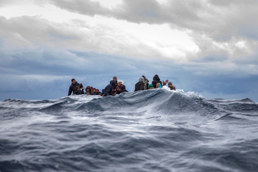 Migrants crowded on a small boat in rough seas off the coast of Libya