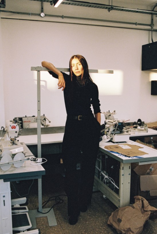 Julie Pelipas in her London studio, surrounded by fabric samples and design materials