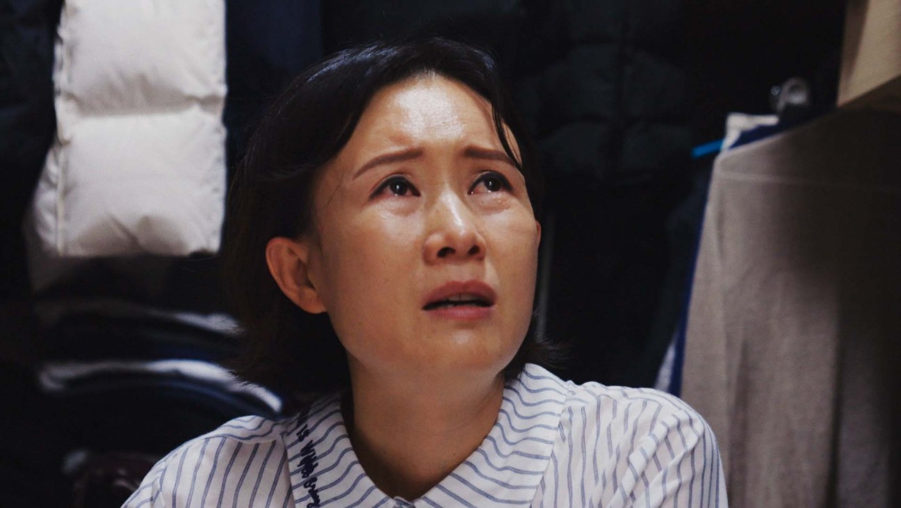 Still from Beyond Utopia documentary showing a North Korean defector in what appears to be a modest living space