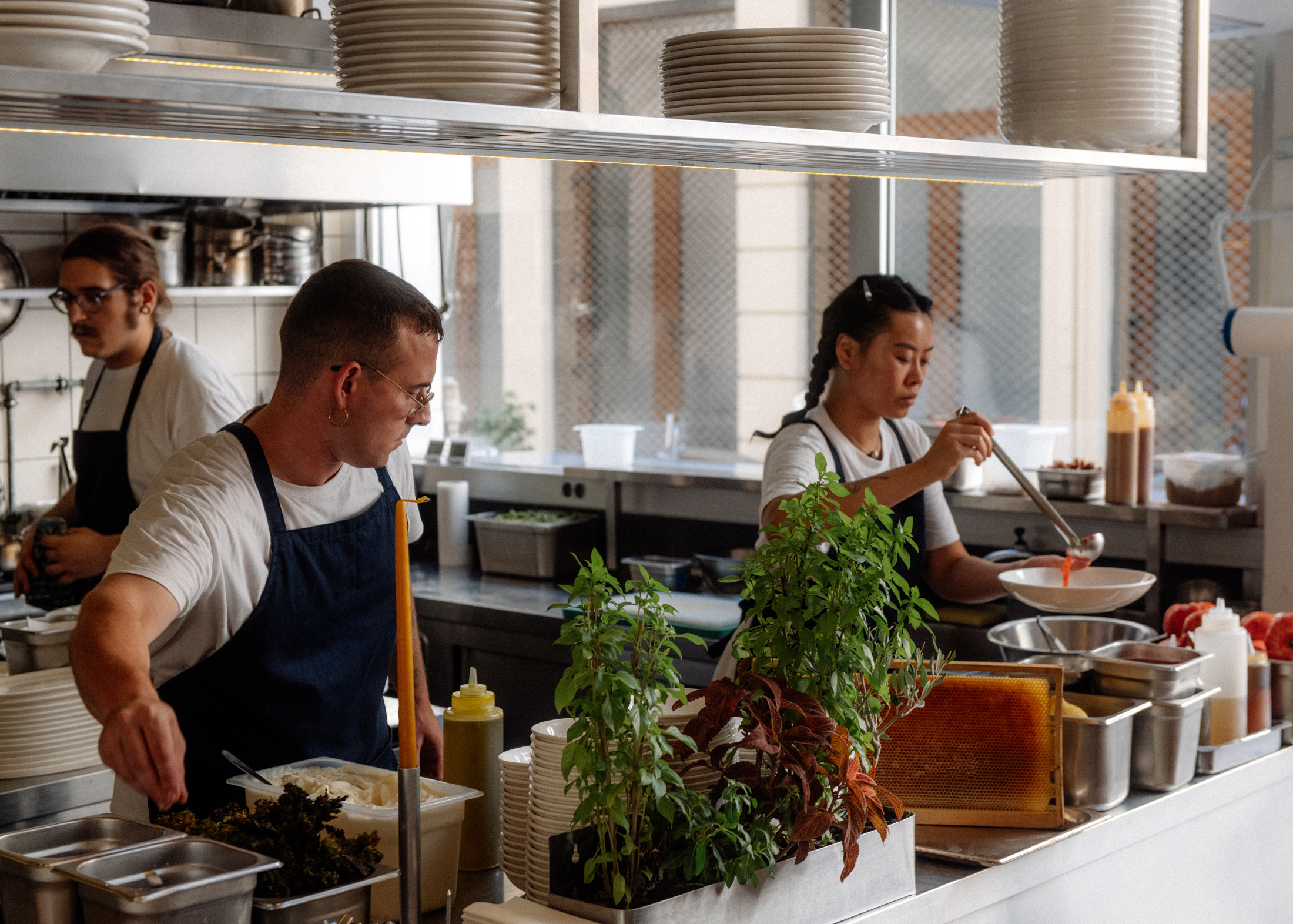 Chefs working at a kitchen at Linou Soumpasis k Sia.