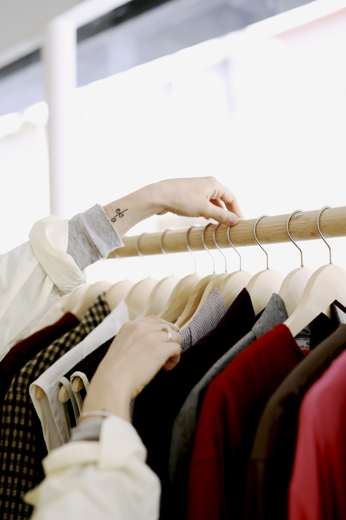 Christina Christodoulou arranging clothes on a rail.