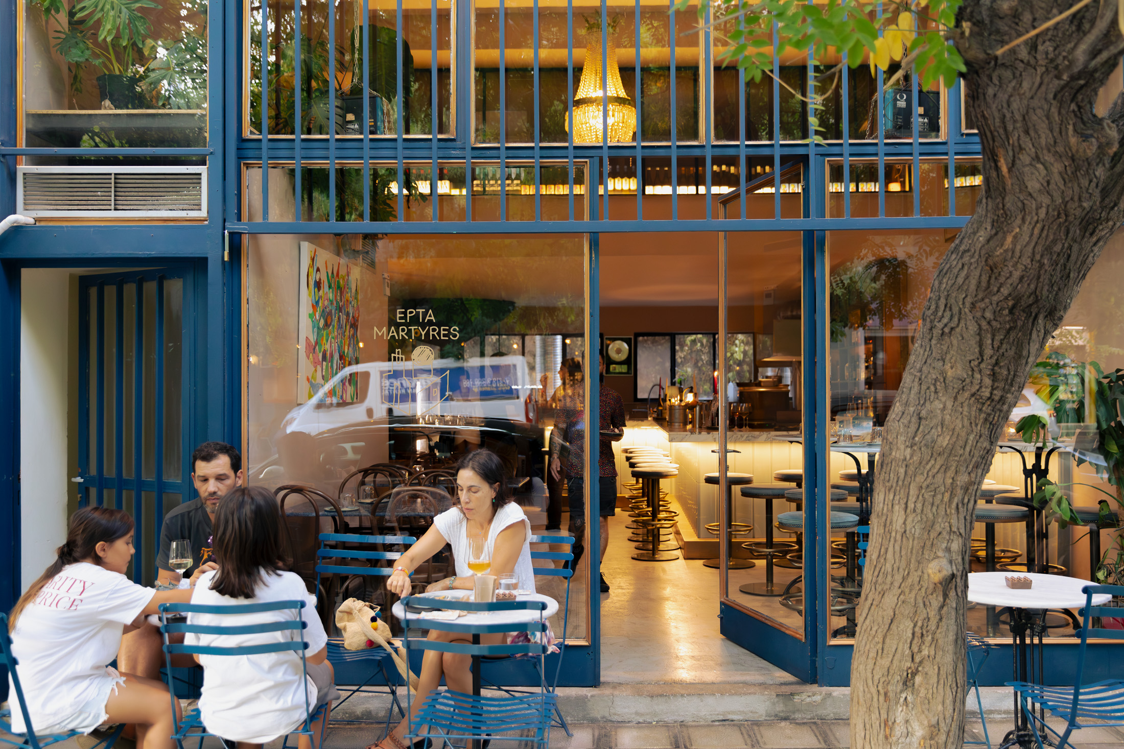 Diners sitting at the front of Epta Martyres in Athens.