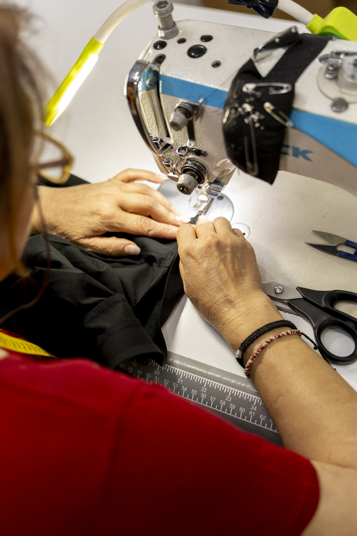 A lady at a sewing machine.