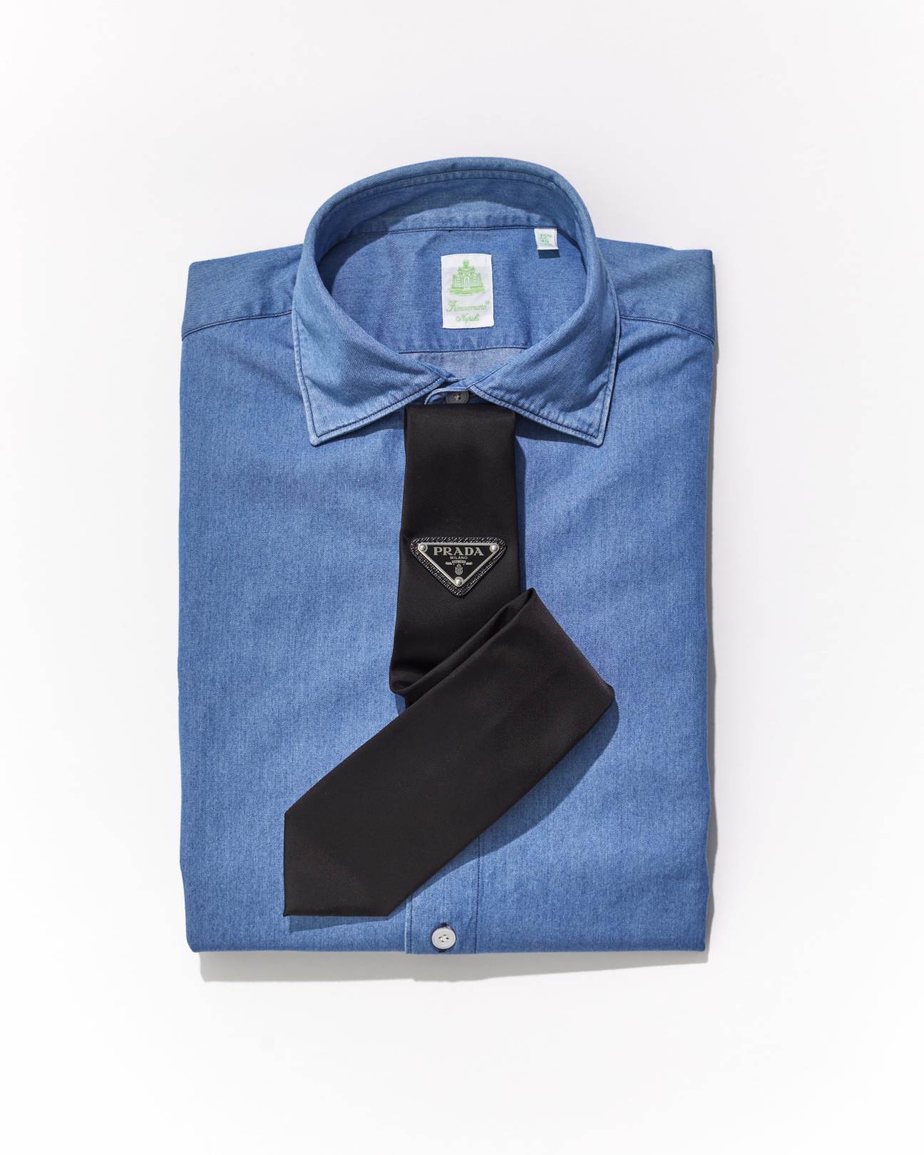 Black Prada tie with triangular logo worn with light blue dress shirt
