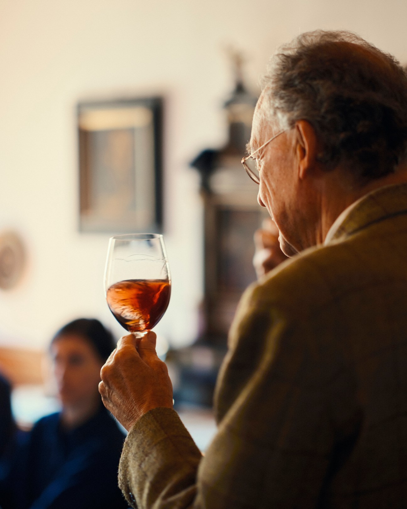 Alois Lageder examining wine in a glass at the Summa organic wine fair