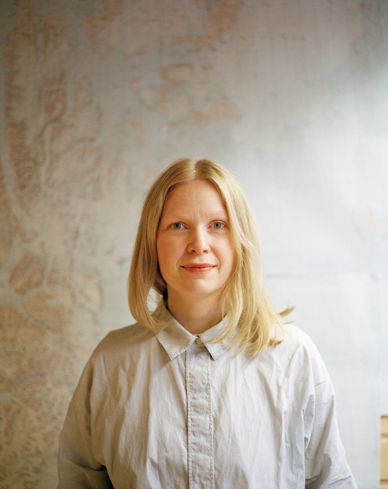 35-year-old woman working at computer in newspaper office