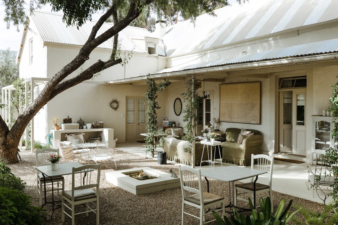 Pebbled courtyard at Prince Albert Country Stay with outdoor seating area under large tree
