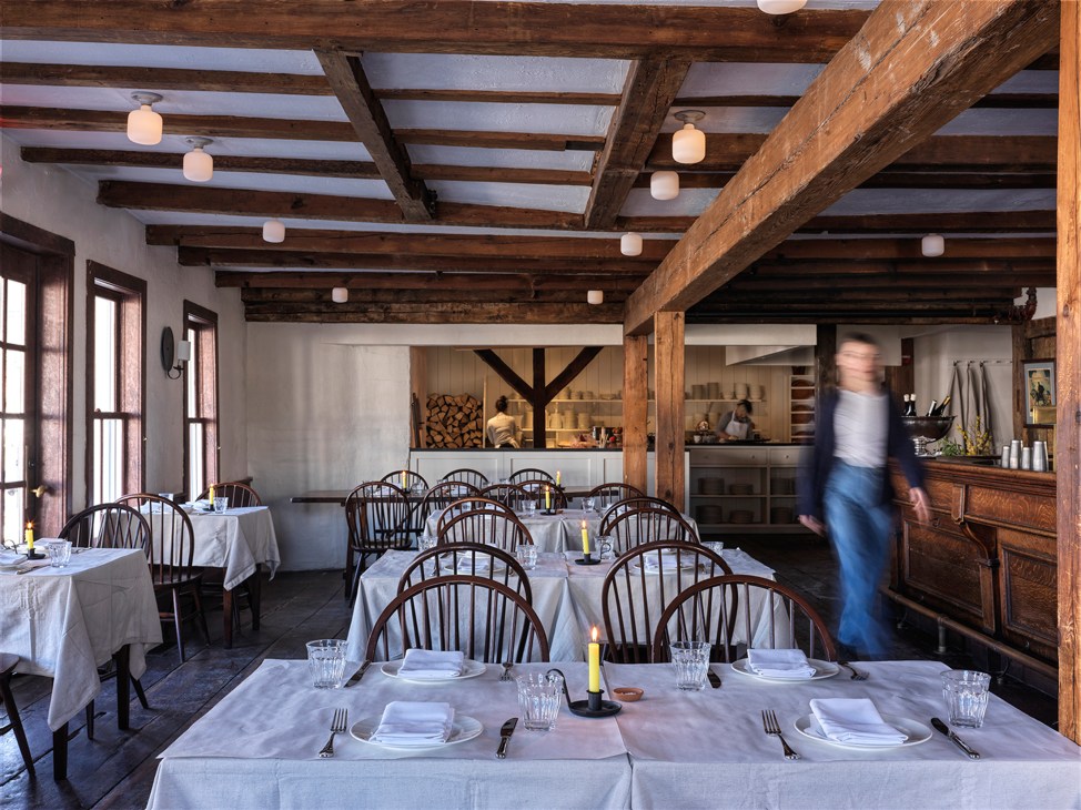 Historic interior of Stissing House tavern showing wooden beams and fireplace from 1782