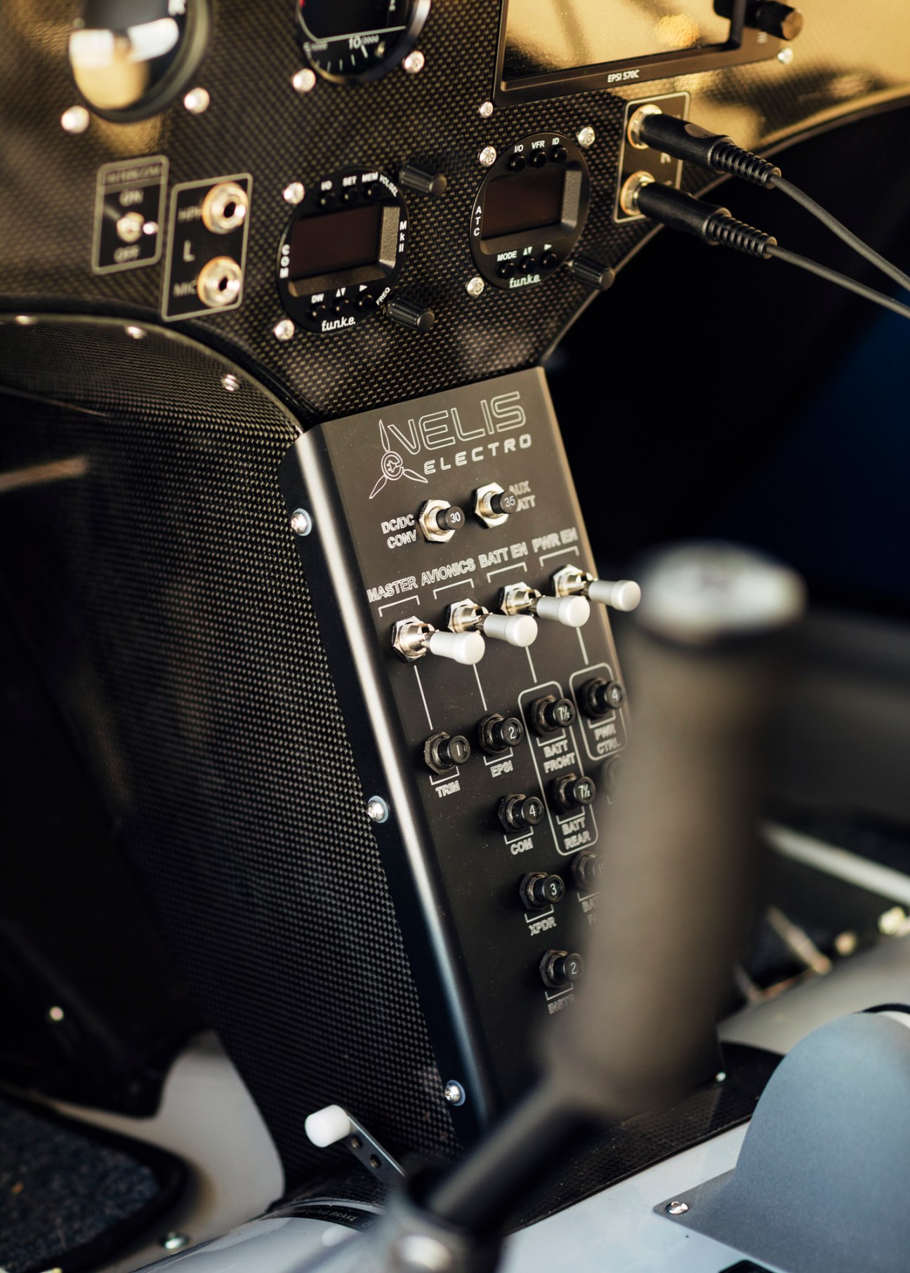 Interior view of electric aircraft cockpit showing controls and seats