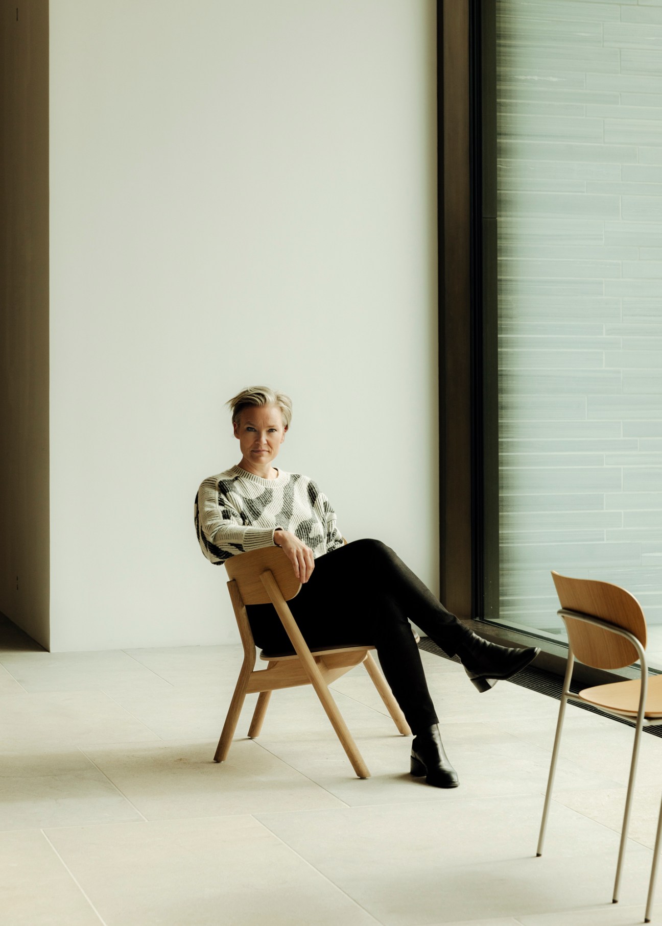Yngvill Sjösteen, project leader for Norway's National Museum, sits in a minimalist white gallery space.