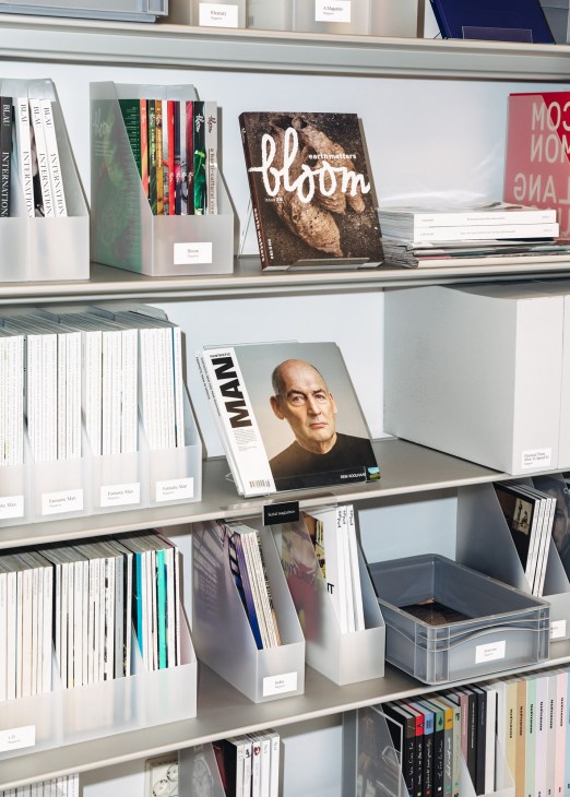 Fashion magazines and publications organized on modern aluminum shelving systems in the library