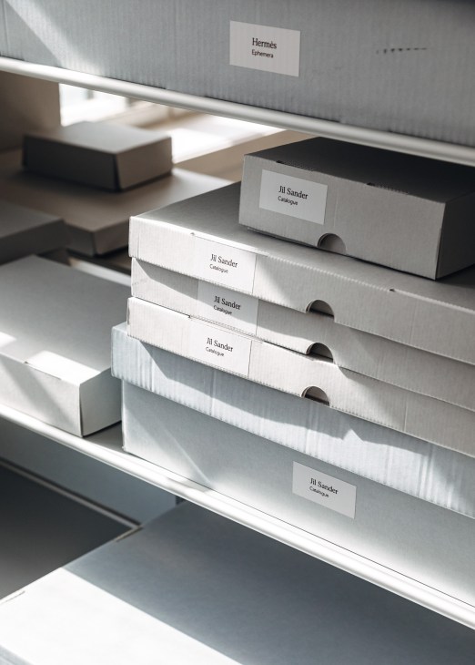 Fashion designer archive materials and documents displayed in organized storage at the International Library of Fashion Research