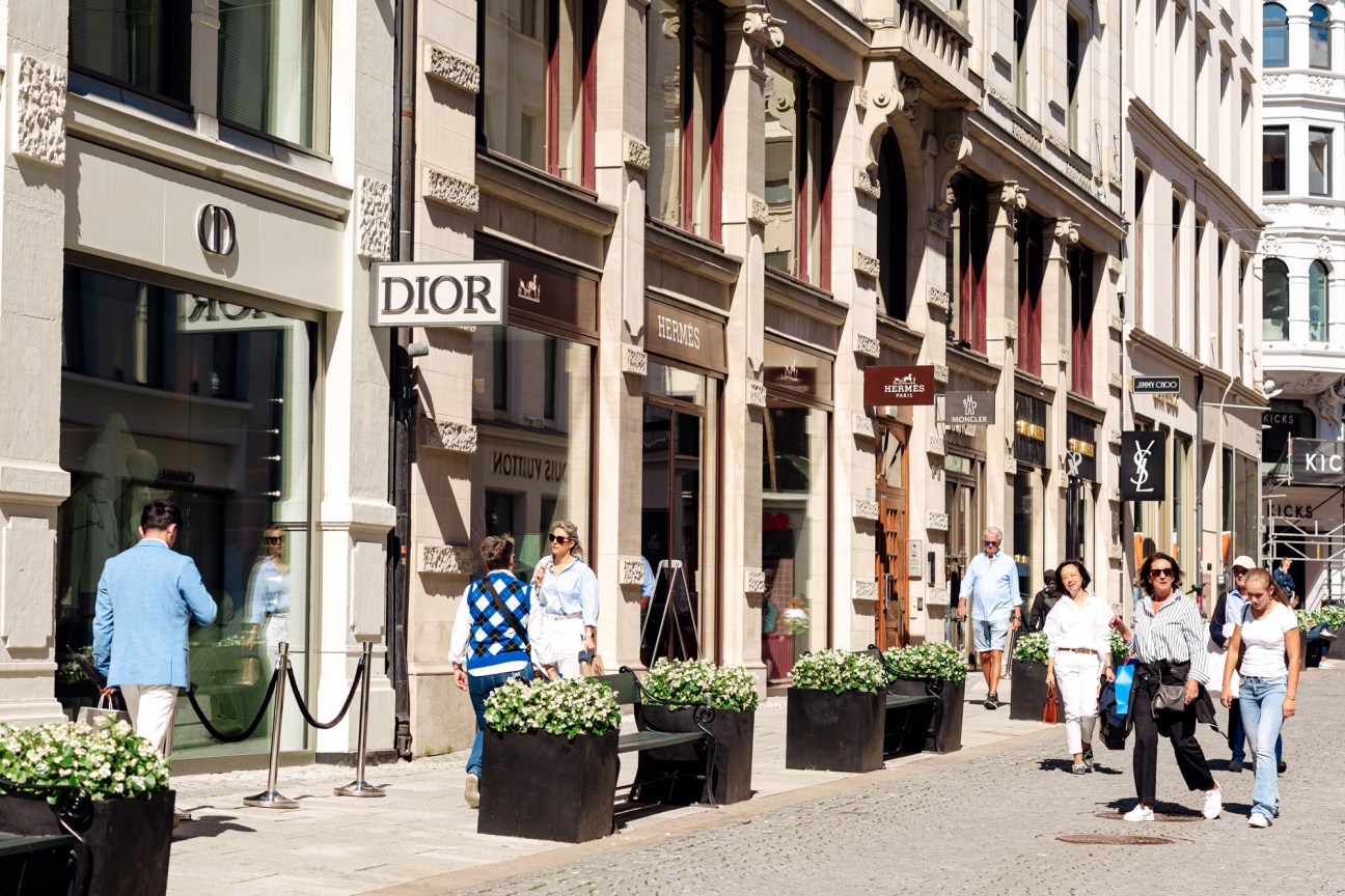 Luxury fashion boutique storefronts along Oslo's Nedre Slottsgate pedestrian shopping street