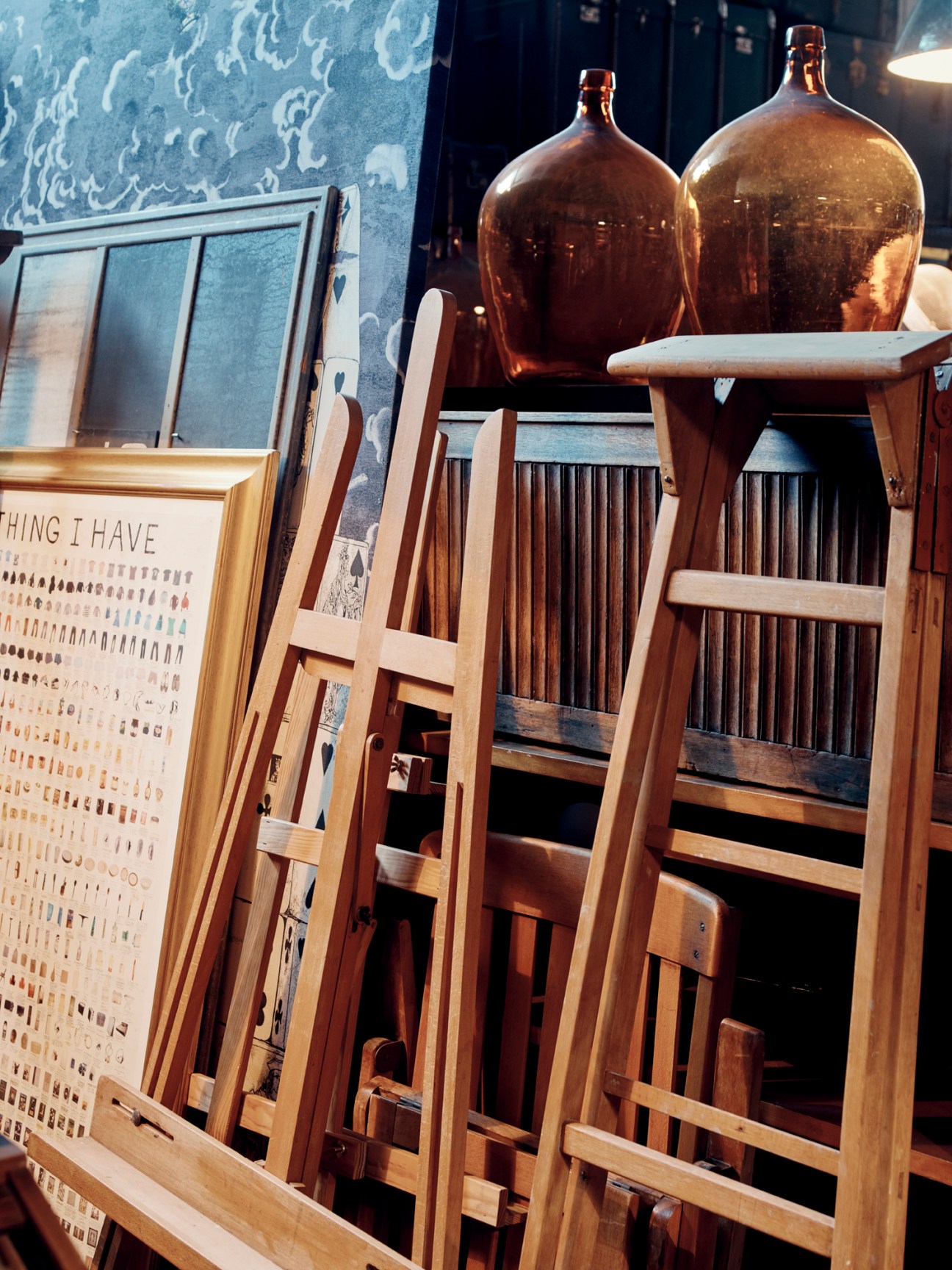 Collection of vintage wooden easels arranged in a showroom space
