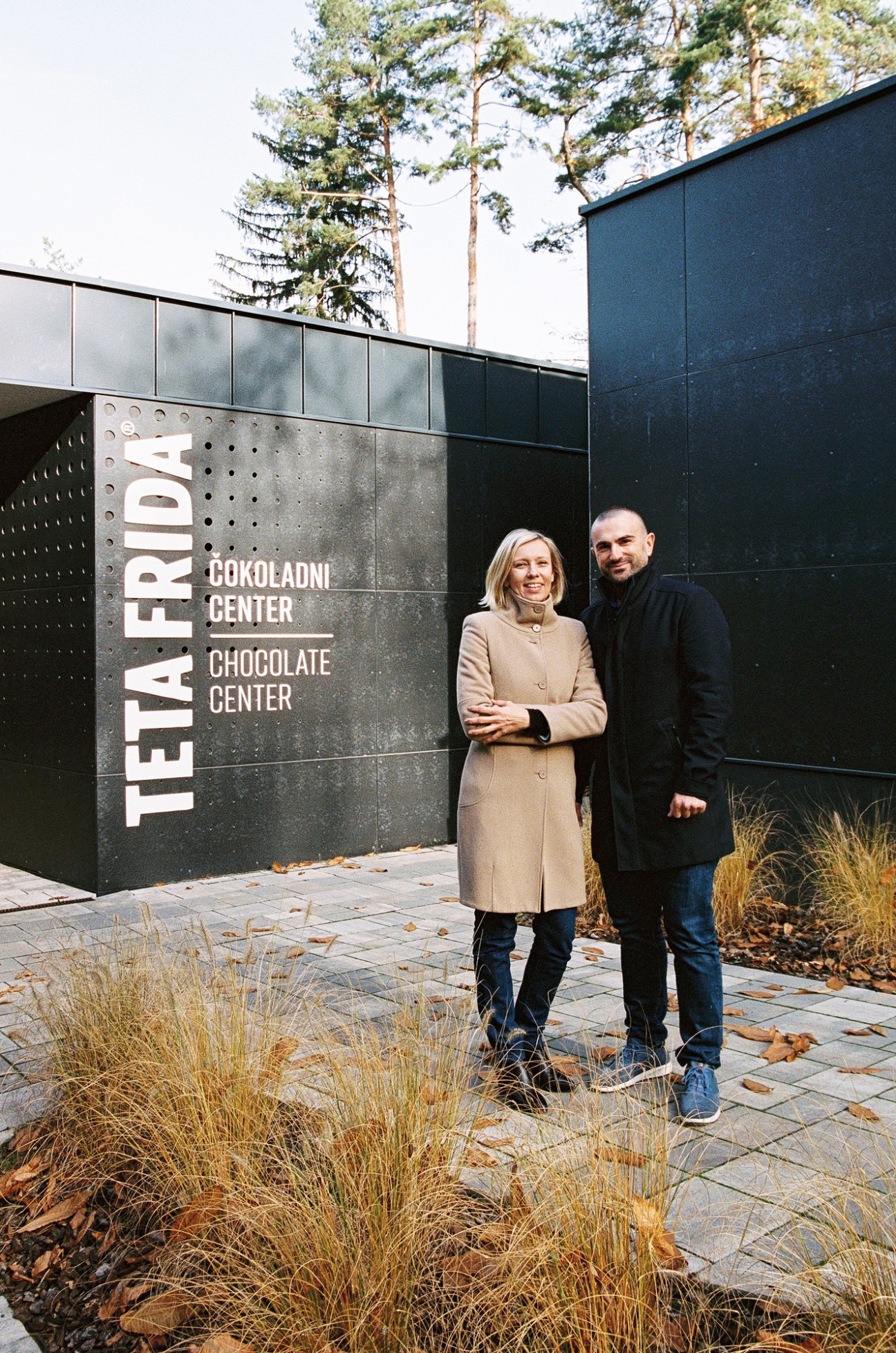Tanja Golob and Uros Mlakar standing outside the Teta Frida chocolate center building