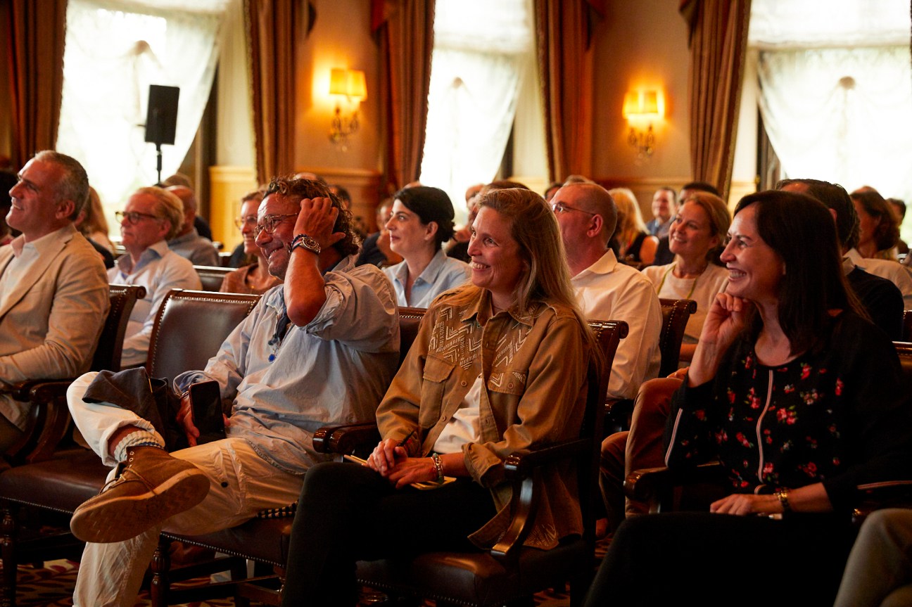 Audience members laughing and smiling while seated in leather chairs at The Chiefs Conference in 2020