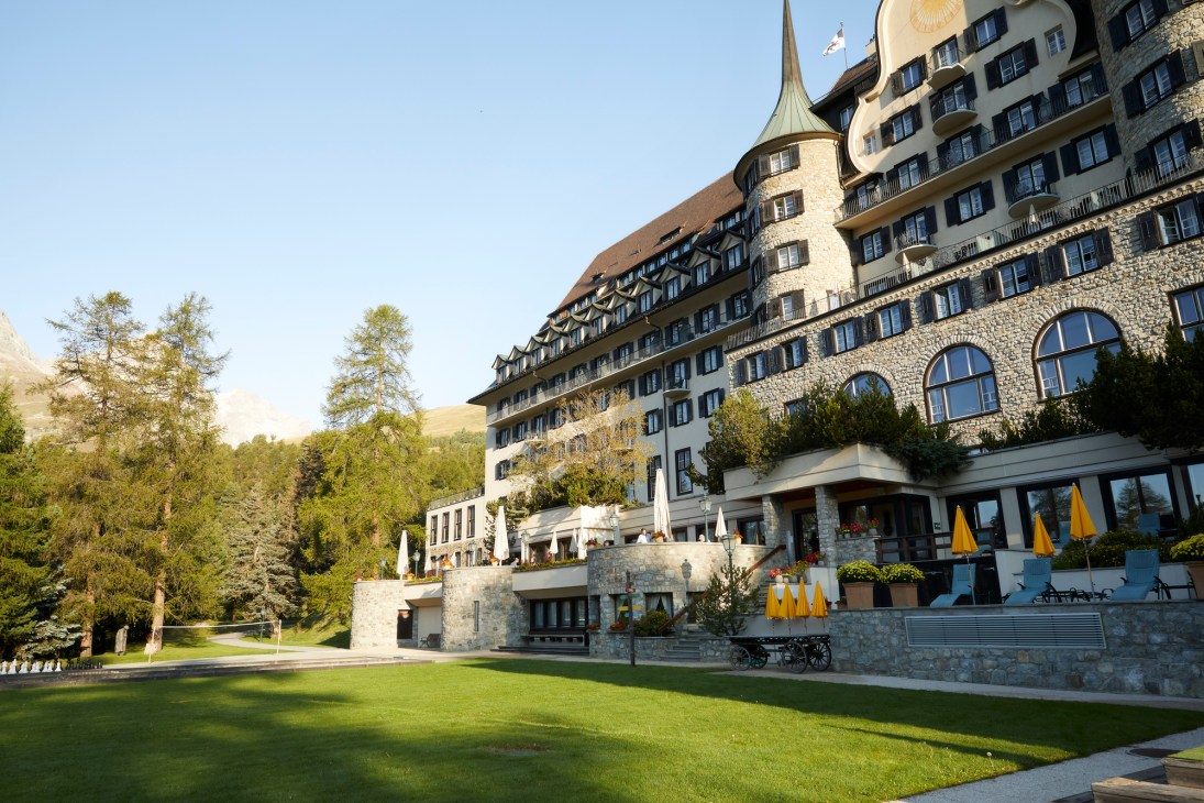 Suvretta House hotel in St Moritz with distinctive architecture, alpine mountains and grounds.