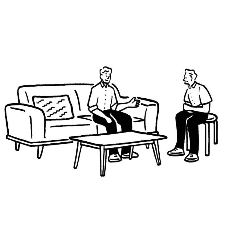 Two men conversing in a minimalist office lounge with sofa, chairs, and coffee table.