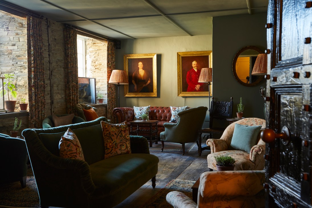 Cozy hotel lounge with leather furniture, portrait paintings, and traditional decor at The Pig at Harlyn Bay