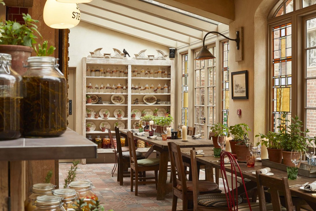 Restaurant interior at The Pig at Bridge Place showing rustic country-house hotel dining room