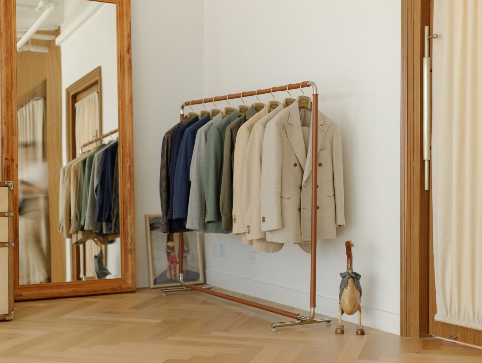 Interior of The Anthology's Hong Kong showroom with suits and accessories on display