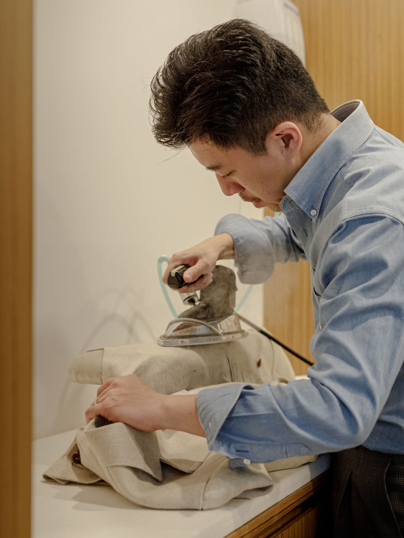 Close-up of hands applying finishing touches to a tailored garment
