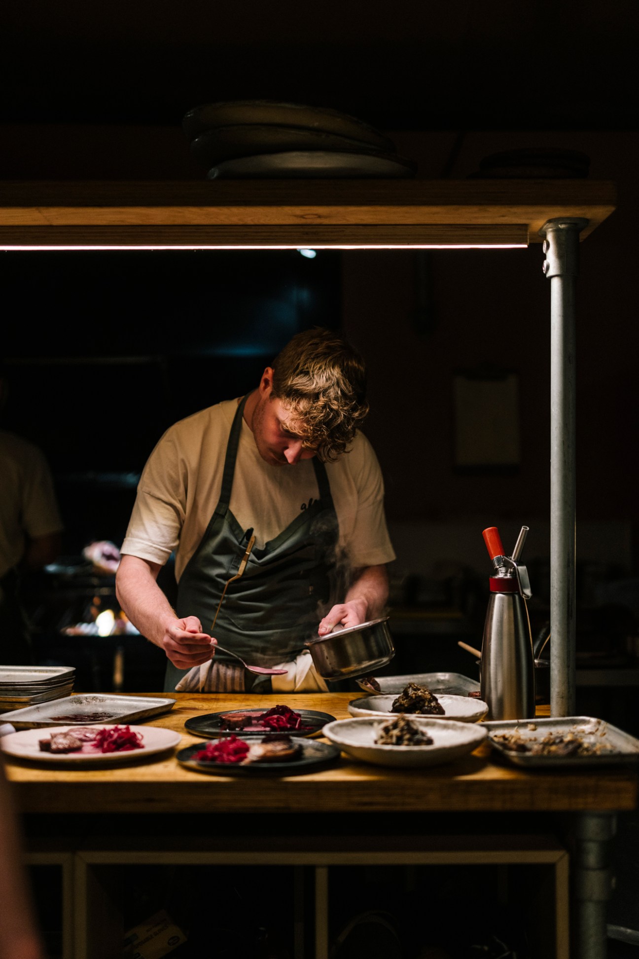 Interior of Allta Winterhouse restaurant showing cosy lighting, sheepskin throws and warm wooden finishes
