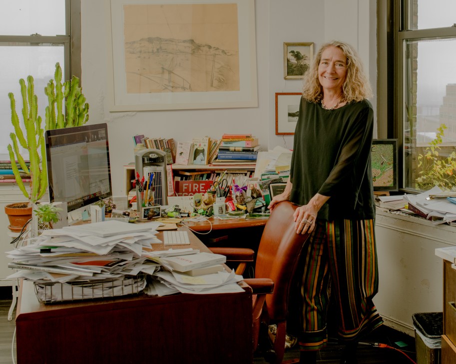 Barbara Epler, president of New Directions publishing house, poses in her downtown Manhattan office surrounded by books and papers.