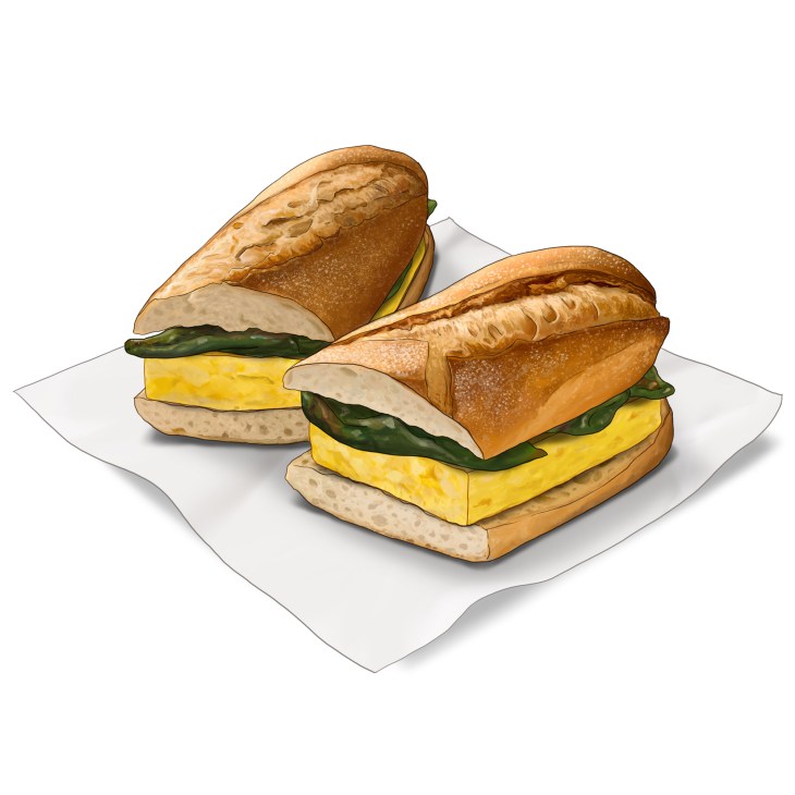 Two tortilla bocadillo sandwiches cut in half showing yellow egg filling and green peppers on white paper