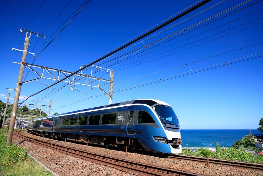 Saphir Odoriko train traveling along coastal railway with ocean view