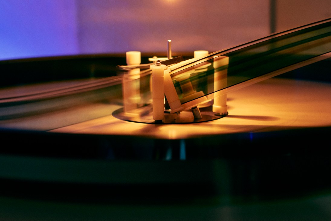 Close-up of vintage film projection equipment with golden metallic components and reels