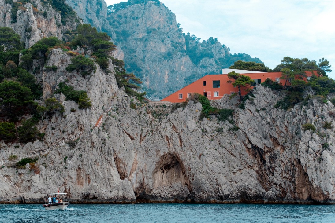 Casa Malaparte, a red rectangular modernist villa with stepped rooftop terrace on rocky Capri coastline