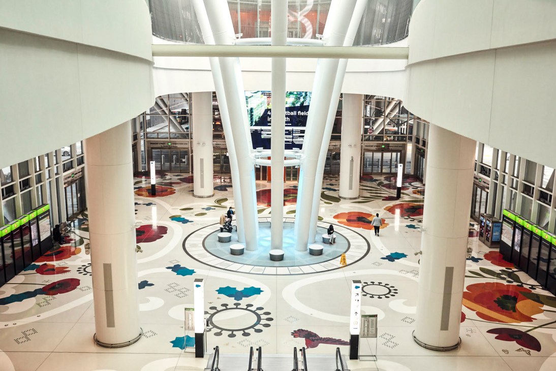 Interior view of San Francisco's Salesforce Transit Center showing modern white columns and colorful floor patterns