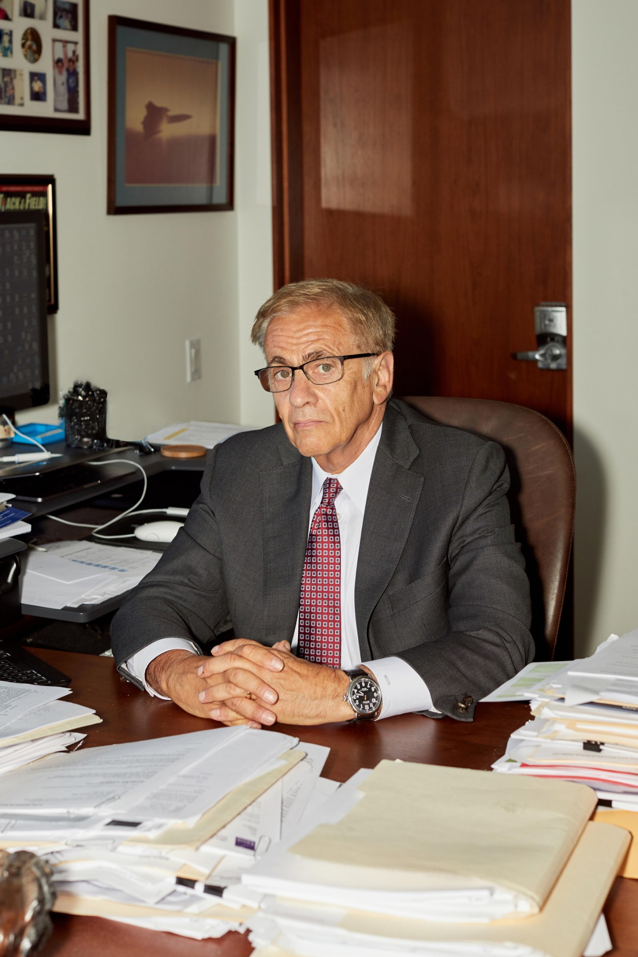 Rand Corporation CEO Michael D Rich seated at his desk in his office.