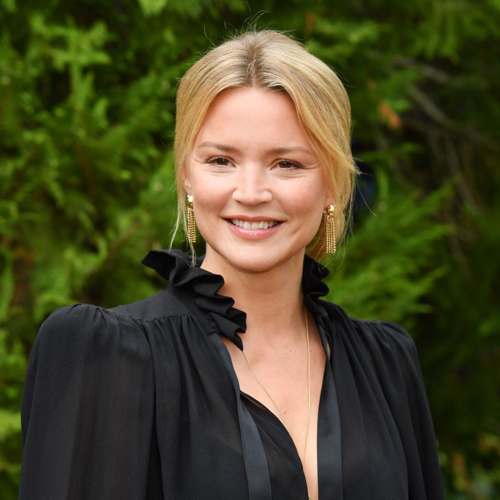Belgian actress Virginie Efira at an outdoor event wearing a black ruffled top and gold earrings
