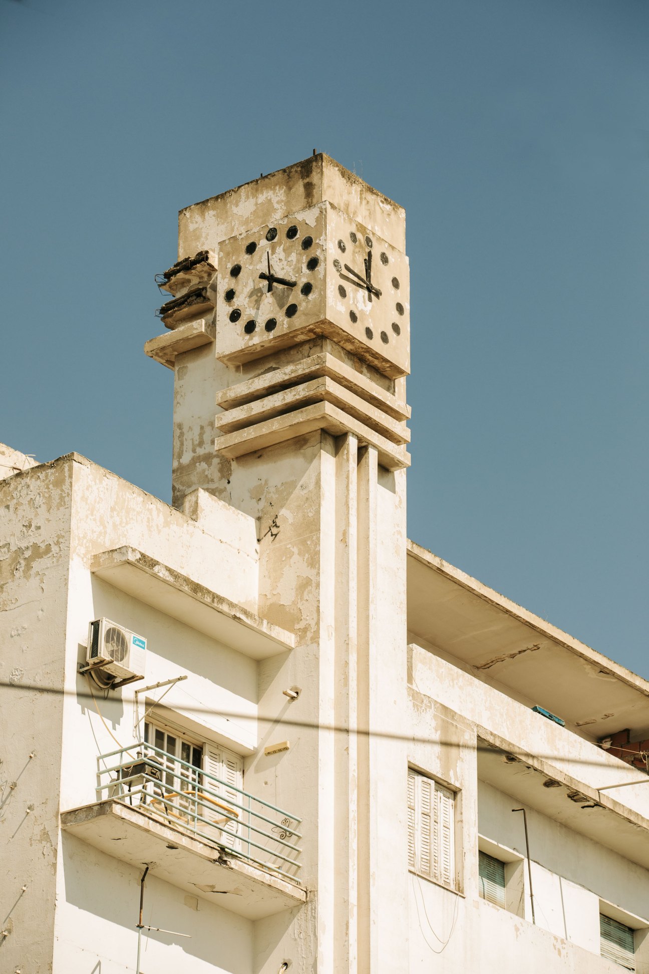 Historic clock tower in Le Passage Square showing colonial-era architecture