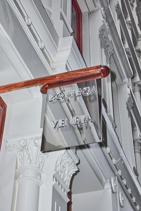 Bottega Veneta storefront sign in Soho, New York, featuring ornate classical architectural details.