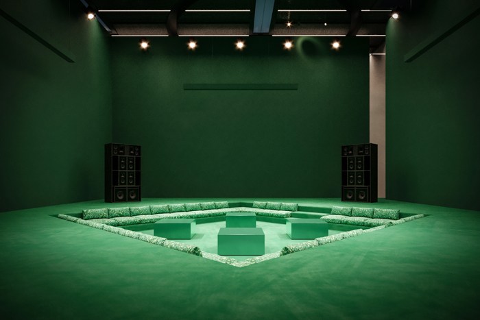 Green room with geometric seating arrangement and speakers, The Square Dubai cultural project by Bottega Veneta.