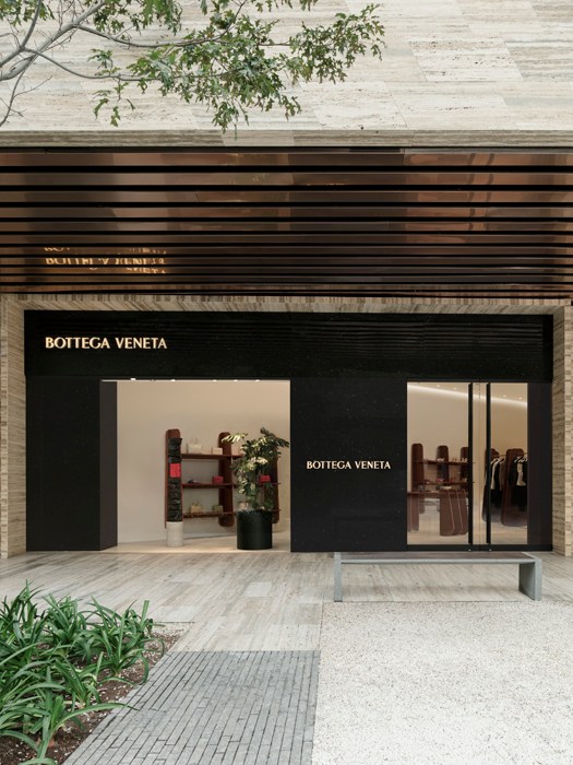 Bottega Veneta storefront in Mexico City with black and white minimalist facade and large windows.